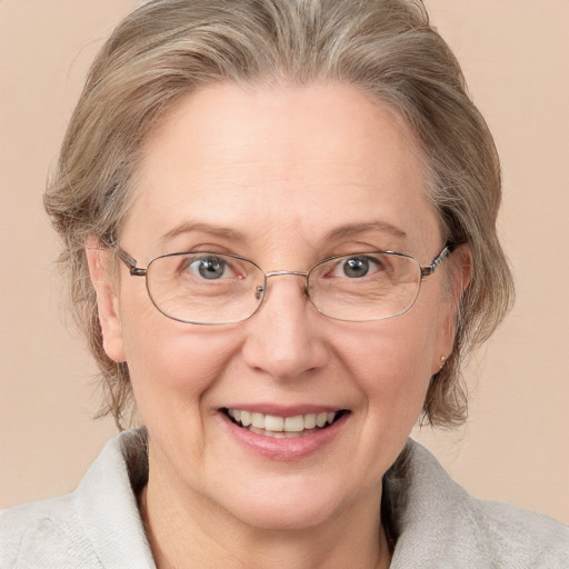 Joyful white middle-aged female with medium  brown hair and blue eyes