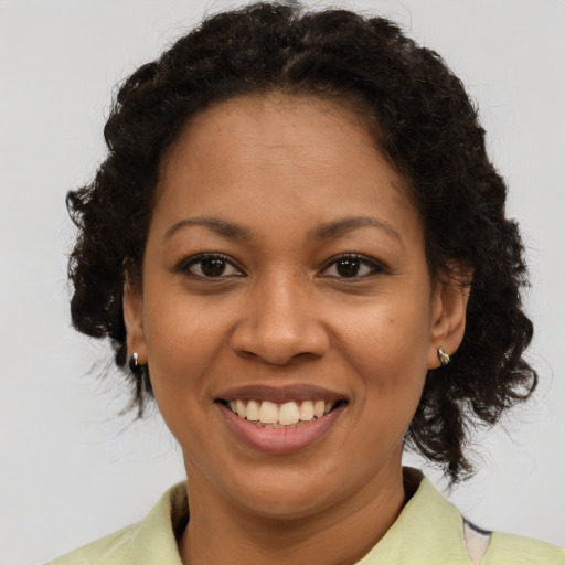 Joyful latino adult female with medium  brown hair and brown eyes