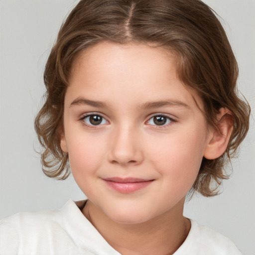 Joyful white child female with medium  brown hair and brown eyes