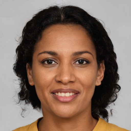 Joyful black young-adult female with medium  brown hair and brown eyes