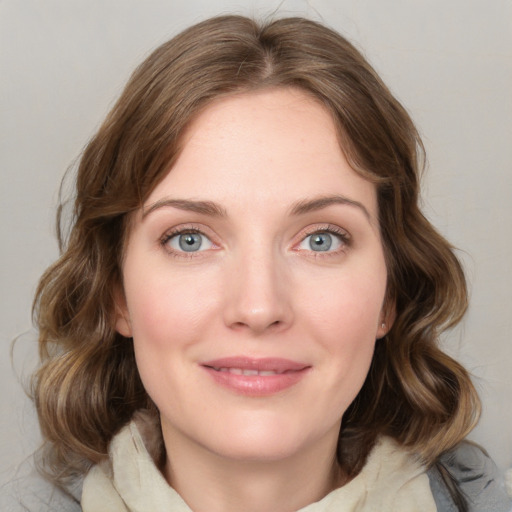 Joyful white young-adult female with medium  brown hair and blue eyes