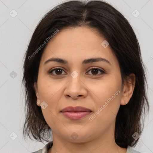 Joyful latino young-adult female with medium  brown hair and brown eyes