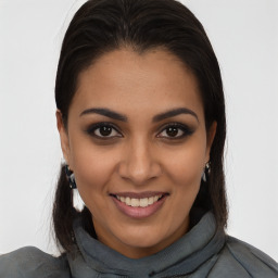 Joyful latino young-adult female with medium  brown hair and brown eyes