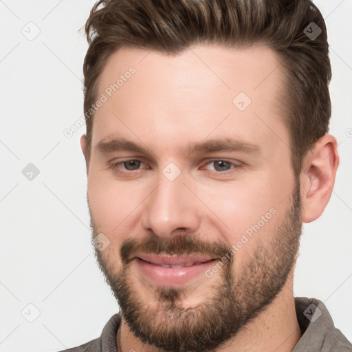 Joyful white young-adult male with short  brown hair and brown eyes