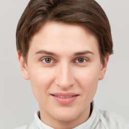 Joyful white young-adult female with short  brown hair and grey eyes