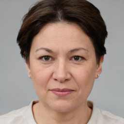 Joyful white adult female with short  brown hair and brown eyes