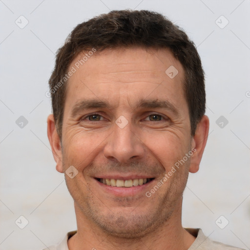 Joyful white adult male with short  brown hair and brown eyes