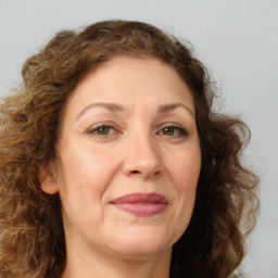 Joyful white adult female with long  brown hair and brown eyes