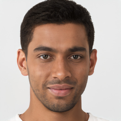 Joyful latino young-adult male with short  brown hair and brown eyes