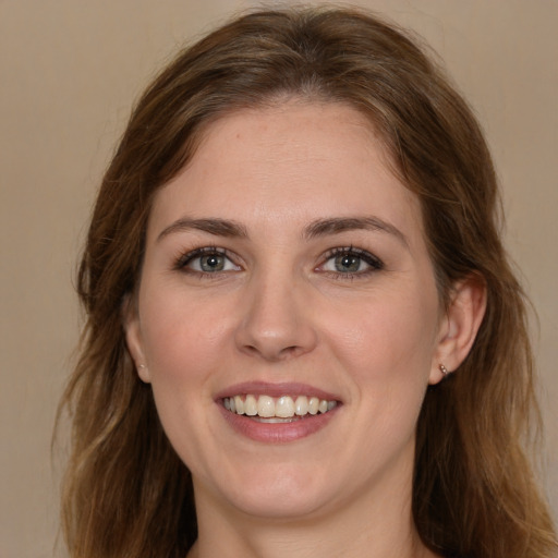 Joyful white young-adult female with long  brown hair and brown eyes