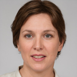 Joyful white adult female with medium  brown hair and grey eyes