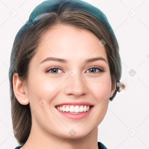 Joyful white young-adult female with long  brown hair and blue eyes