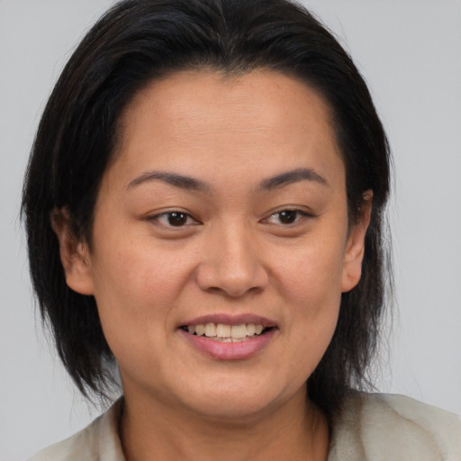 Joyful asian young-adult female with medium  brown hair and brown eyes