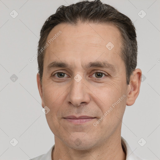 Joyful white adult male with short  brown hair and brown eyes