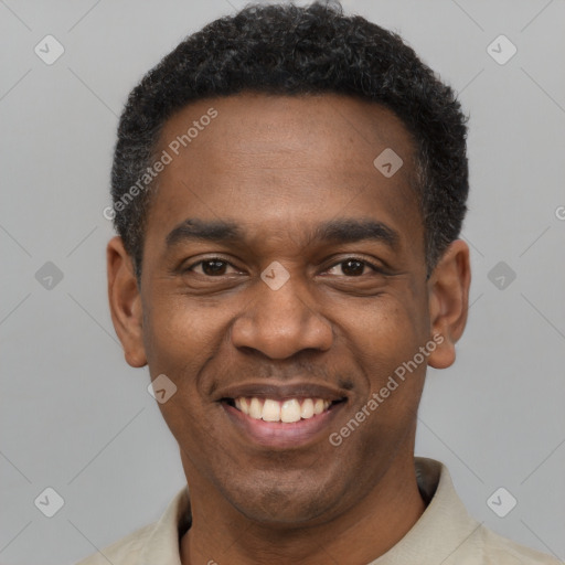 Joyful black young-adult male with short  black hair and brown eyes