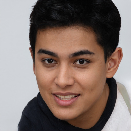 Joyful latino young-adult male with short  brown hair and brown eyes