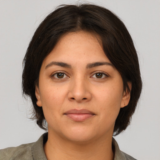 Joyful white young-adult female with medium  brown hair and brown eyes