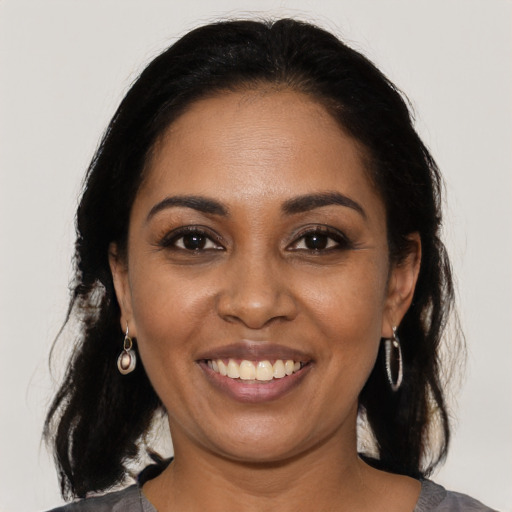 Joyful black young-adult female with medium  brown hair and brown eyes