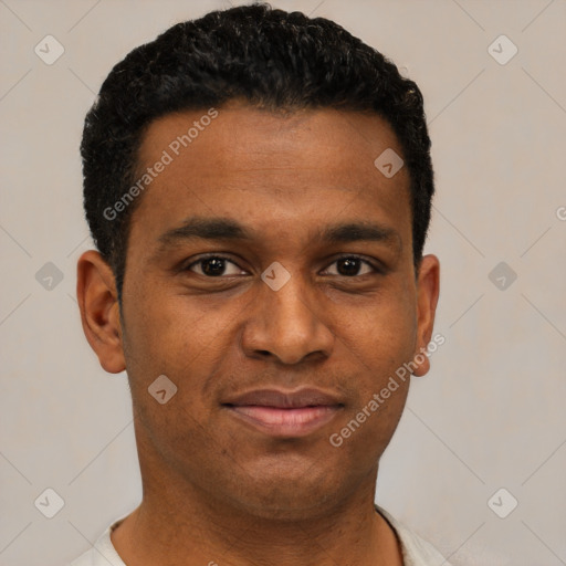 Joyful black young-adult male with short  black hair and brown eyes