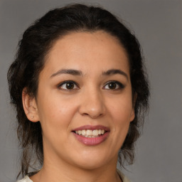 Joyful latino young-adult female with medium  brown hair and brown eyes