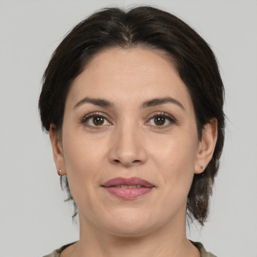 Joyful white adult female with medium  brown hair and brown eyes