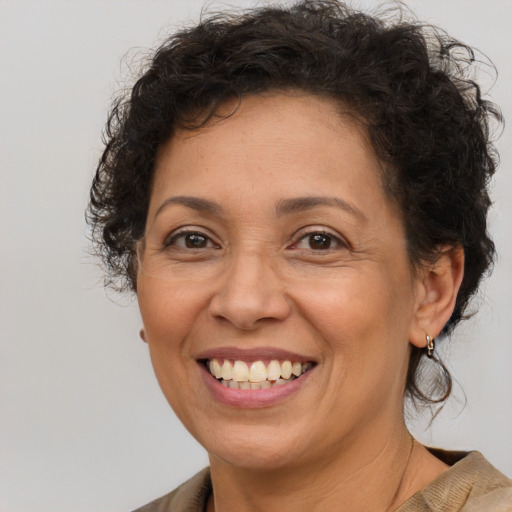 Joyful latino adult female with medium  brown hair and brown eyes