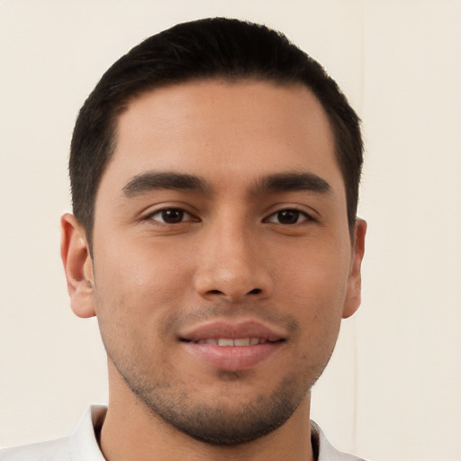 Joyful latino young-adult male with short  brown hair and brown eyes