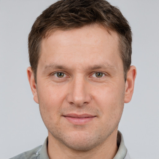 Joyful white adult male with short  brown hair and grey eyes