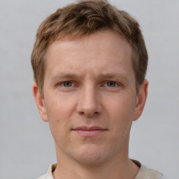 Joyful white adult male with short  brown hair and grey eyes