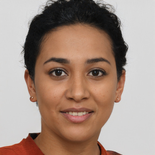Joyful latino young-adult female with short  brown hair and brown eyes
