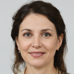 Joyful white adult female with medium  brown hair and brown eyes