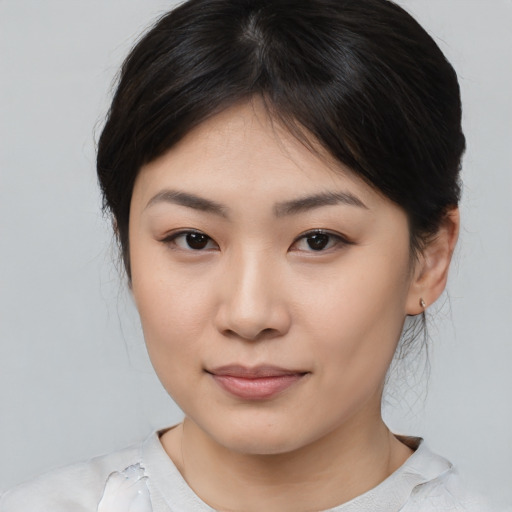 Joyful asian young-adult female with medium  brown hair and brown eyes