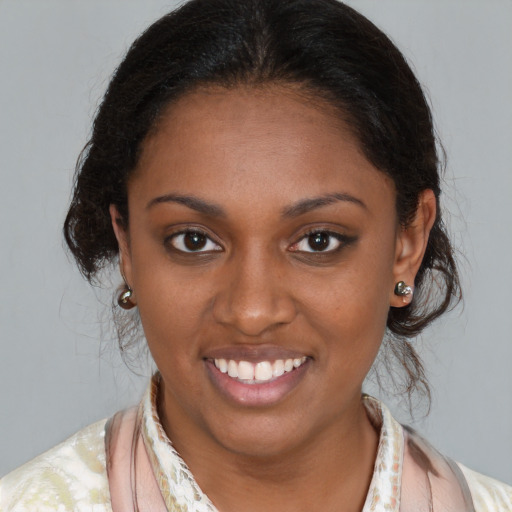 Joyful black young-adult female with medium  brown hair and brown eyes