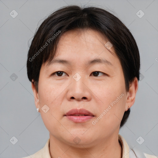 Joyful asian adult female with medium  brown hair and brown eyes