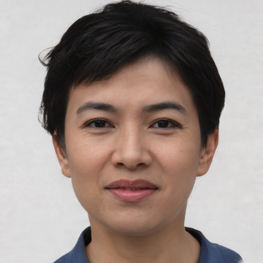 Joyful asian young-adult female with short  black hair and brown eyes