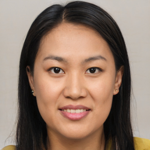 Joyful asian young-adult female with long  brown hair and brown eyes