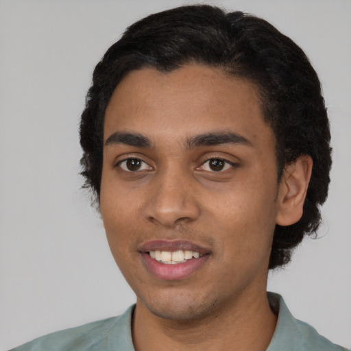 Joyful latino young-adult male with short  black hair and brown eyes