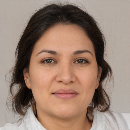 Joyful white adult female with medium  brown hair and brown eyes