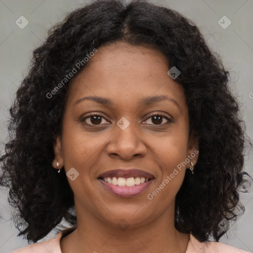 Joyful black young-adult female with long  brown hair and brown eyes