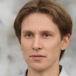 Joyful white adult male with short  brown hair and grey eyes