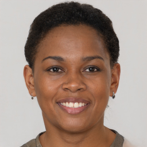 Joyful black young-adult female with short  brown hair and brown eyes