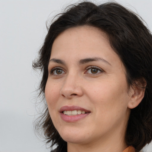 Joyful white adult female with long  brown hair and brown eyes