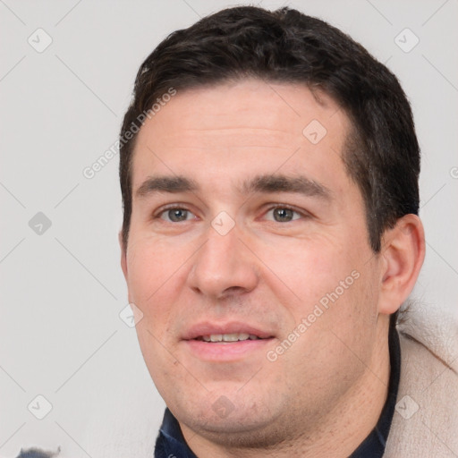 Joyful white adult male with short  brown hair and brown eyes