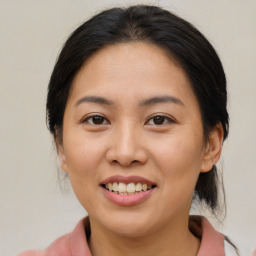 Joyful asian young-adult female with medium  brown hair and brown eyes