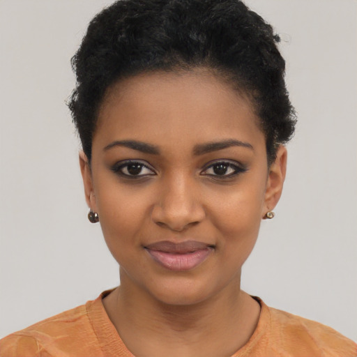 Joyful black young-adult female with short  black hair and brown eyes