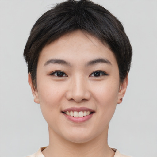 Joyful asian young-adult female with short  brown hair and brown eyes