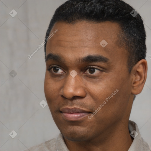 Joyful black young-adult male with short  black hair and brown eyes