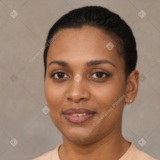 Joyful black young-adult female with short  black hair and brown eyes