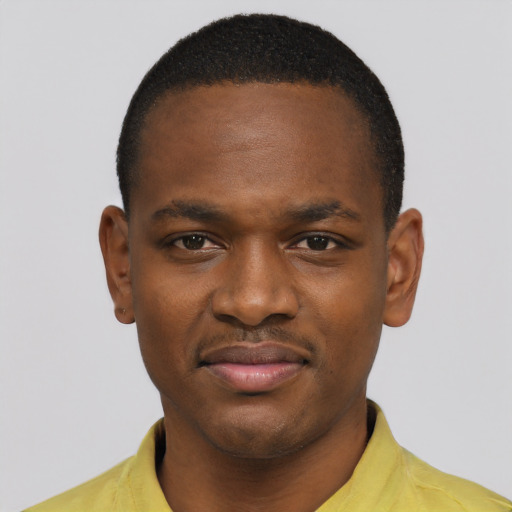 Joyful black young-adult male with short  brown hair and brown eyes