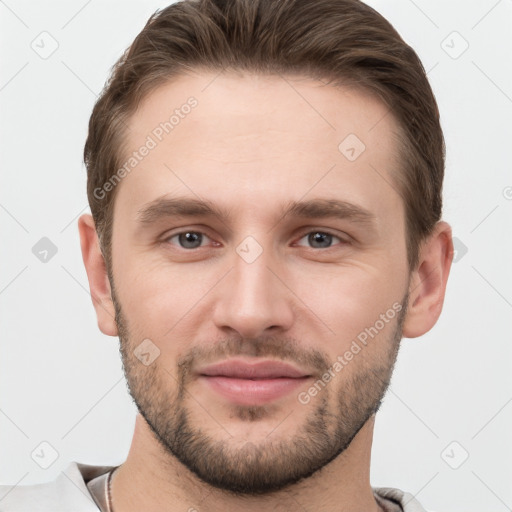 Joyful white young-adult male with short  brown hair and grey eyes